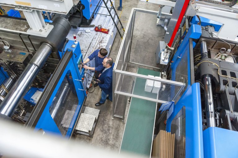 Manager and worker having a work meeting in a plastics facility