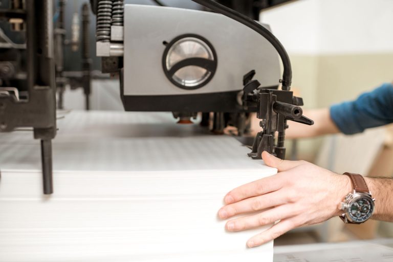 Operator working on printing equipment in a plastics factory